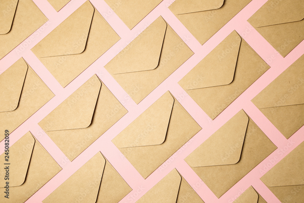 kraft brown paper envelopes on pink background
