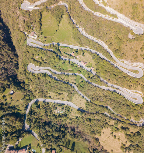 Up and down drone aerial view of the mountain road in Italy from the village of Nembro to Selvino. Amazing aerial view of the mountain bends creating beautiful shapes photo