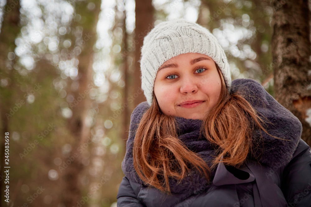 Portrait of a girl in a pine forest on a winter day Portrait of a girl in a pine forest on a winter day