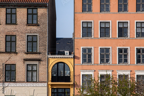 Photography Small house in between tall buildings