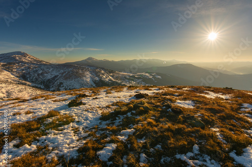Fototapeta Naklejka Na Ścianę i Meble -  A tourist on the top of the mountain at sunrise with beautiful views.