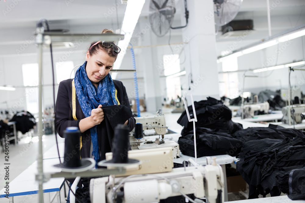 Woman designer working in textile factory Woman designer working in textile factory