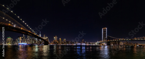 Fototapeta Naklejka Na Ścianę i Meble -  Night wide angle panorama Manhattan panorama with Brooklyn and Manhattan bridges.