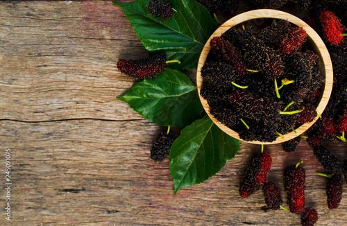 Fresh mulberries fruits in wooden bowl  on wood table backgrounds above