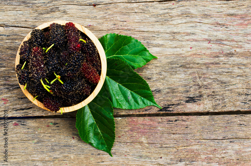 Mulberries organic fruits in wooden bowl on old wood backgrounds above
