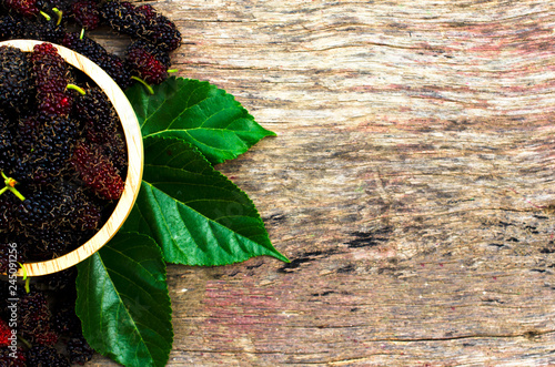 Mulberry fruits on old wood backgrounds above with space for text