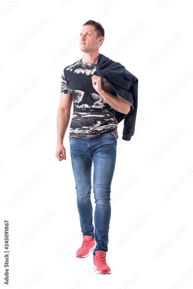 Confident relaxed casual young man walking and looking up carrying jacket on the shoulder. Full body isolated on white background. Confident relaxed casual young man walking and looking up carrying jacket on the shoulder. Full body isolated on white background.