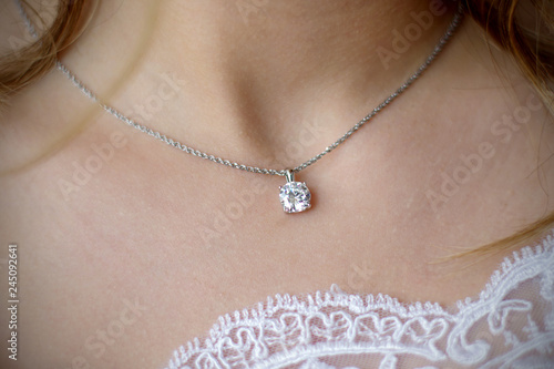 Morning gathering of the bride. Suspension on the neck. Beautiful neckline. Close-up.