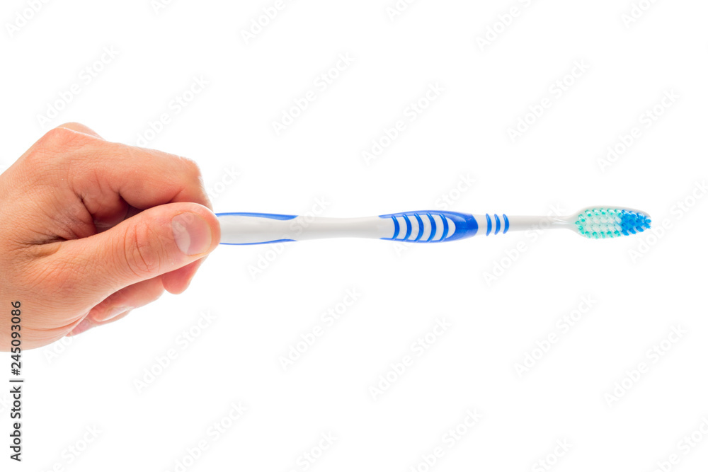 toothbrush in hand on an isolated background toothbrush in hand on an isolated background