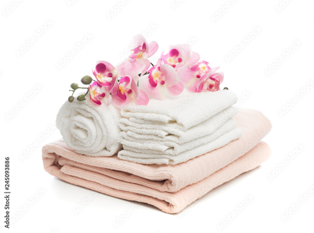 Stack of clean soft towels with orchid flower on white background - Image. Stack of clean soft towels with orchid flower on white background - Image.