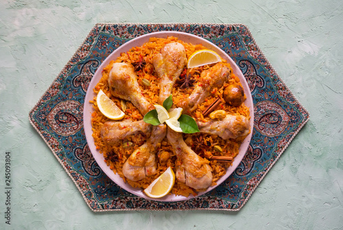 Homemade chicken Biryani. Arabic traditional food bowls kabsa with meat. Top view. 
