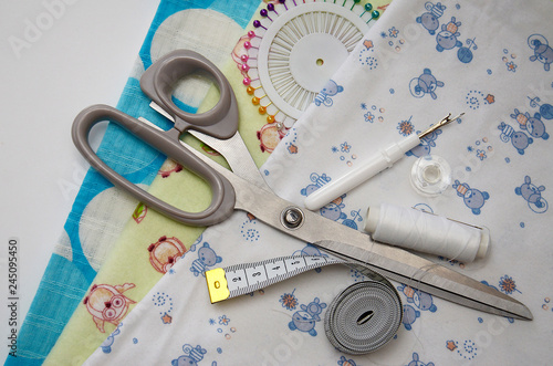 set for sewing different fabric products on a light background photo