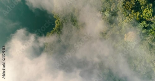 Aerial top amazing overhead shot clouds, lake and forest 4K