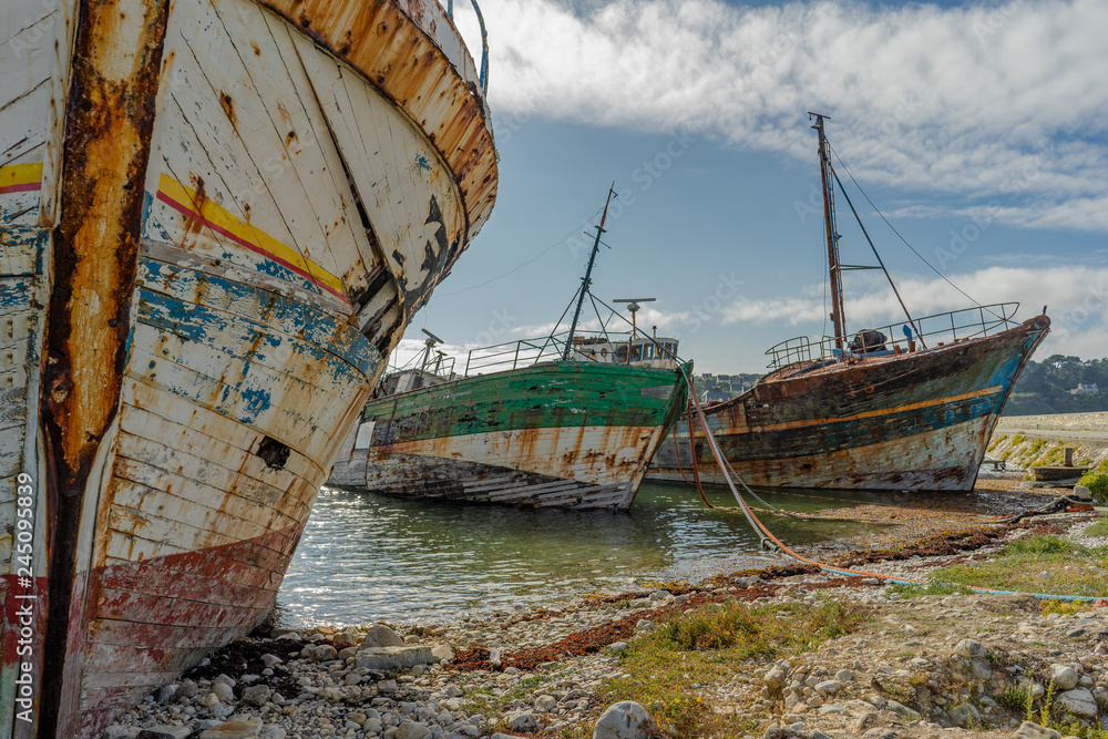 rotting ships with peeling paint and rotten structures on the Cemetery boat in Brittany, France rotting ships with peeling paint and rotten structures on the Cemetery boat in Brittany, France