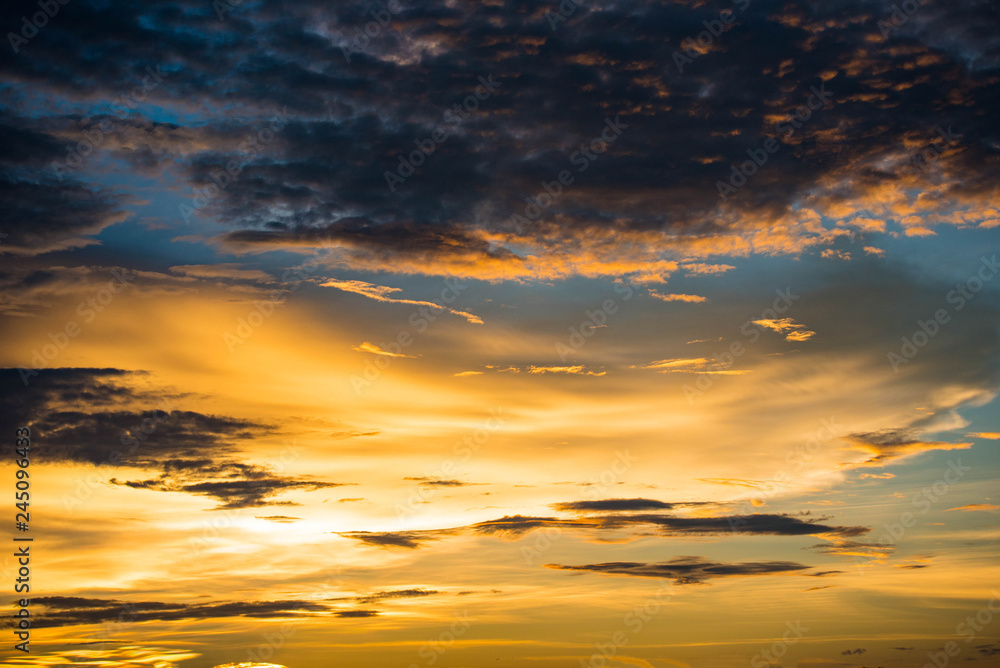 Dramatic sunset colorful yellow sky over and cloud background multicolor evening sky