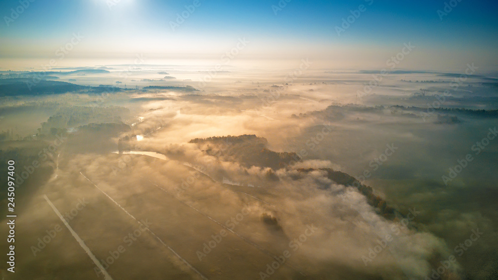 Aerial view of morning foggy sunrise and rural fields