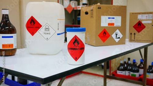 Variety type of chemical container with  many of chemical hazard warning symbols. Flammable warning symbol, Toxic warning symbol, Hazardous to the Environment symbol. photo