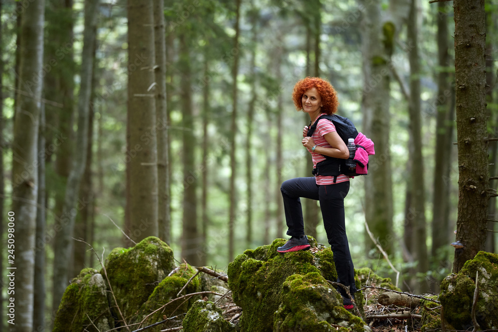 Woman tourist hiking with backpack