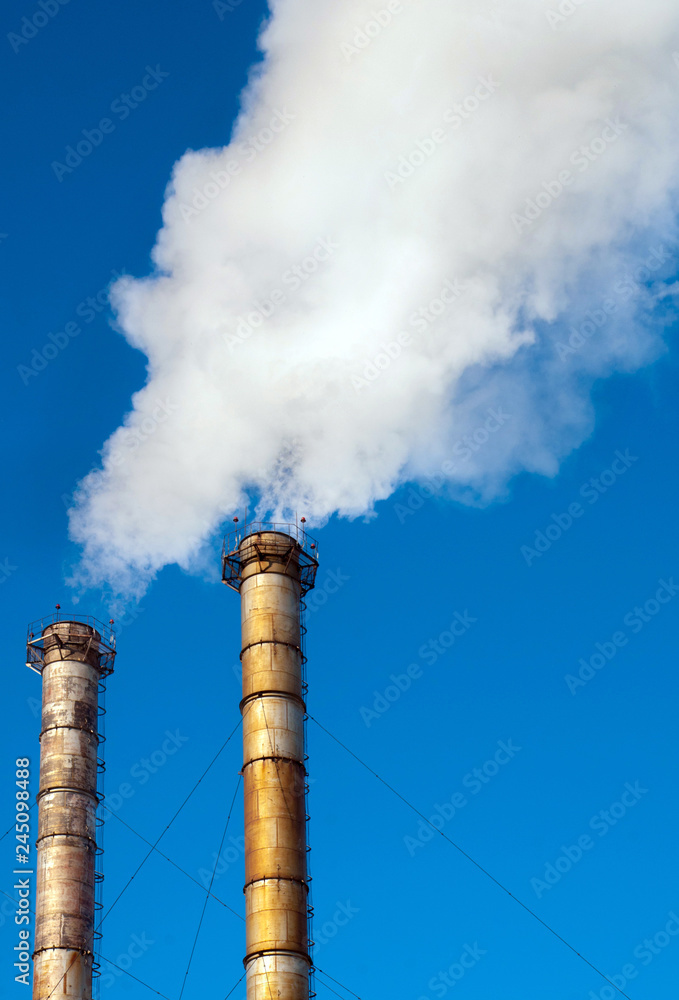 Industrial smoke from chimney on blue sky. Industrial smoke from chimney on blue sky.