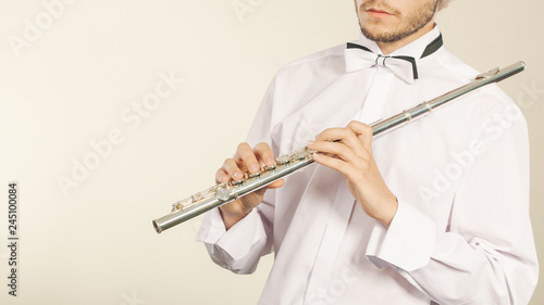 Flute music instrument in hands of flutist musician