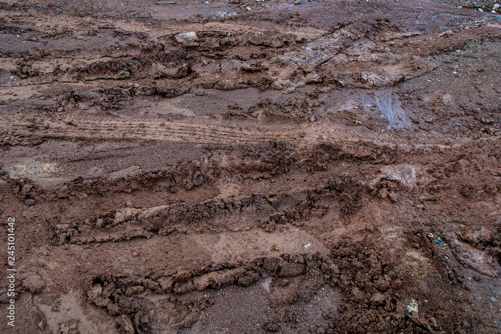 Vehicles Tire Tracks on Mud in the Forrest. Wheel Tracks on the Wet Soil Vehicles Tire Tracks on Mud in the Forrest. Wheel Tracks on the Wet Soil