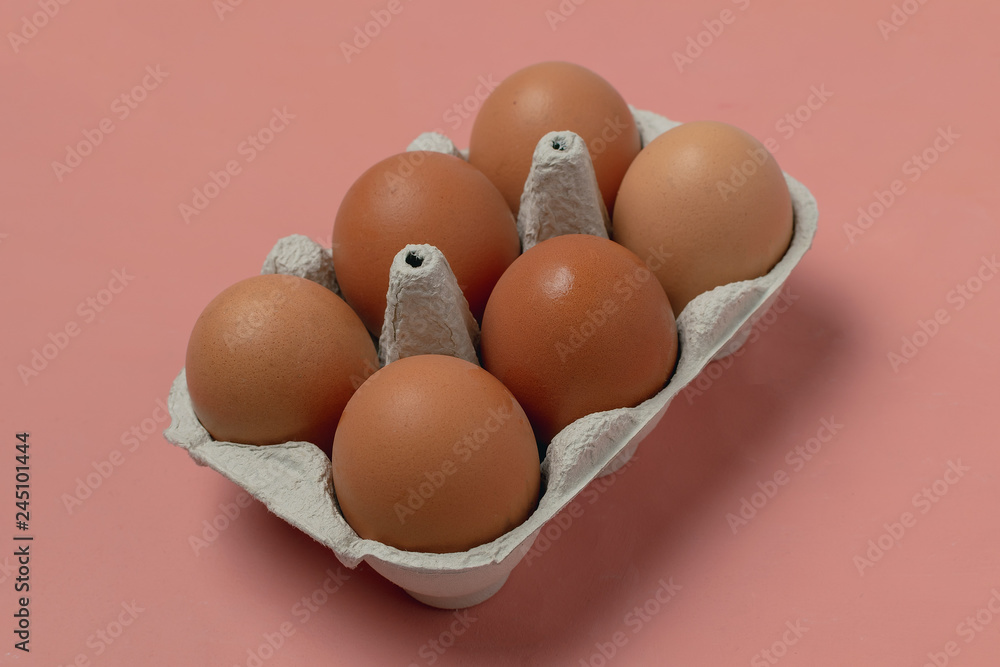 Raw chicken eggs in cardboard container