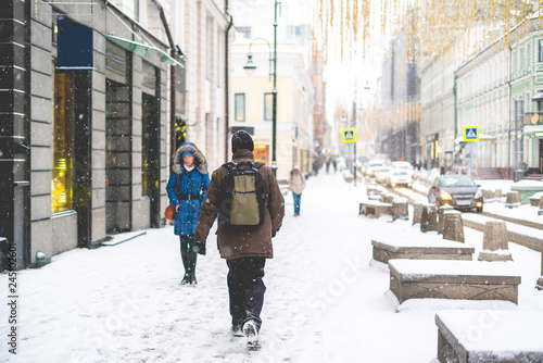 people walk in city streets under snowall b