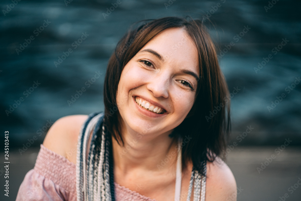 portrait of a girl in heart glasses in front of wall of sea portrait of a girl in heart glasses in front of wall of sea