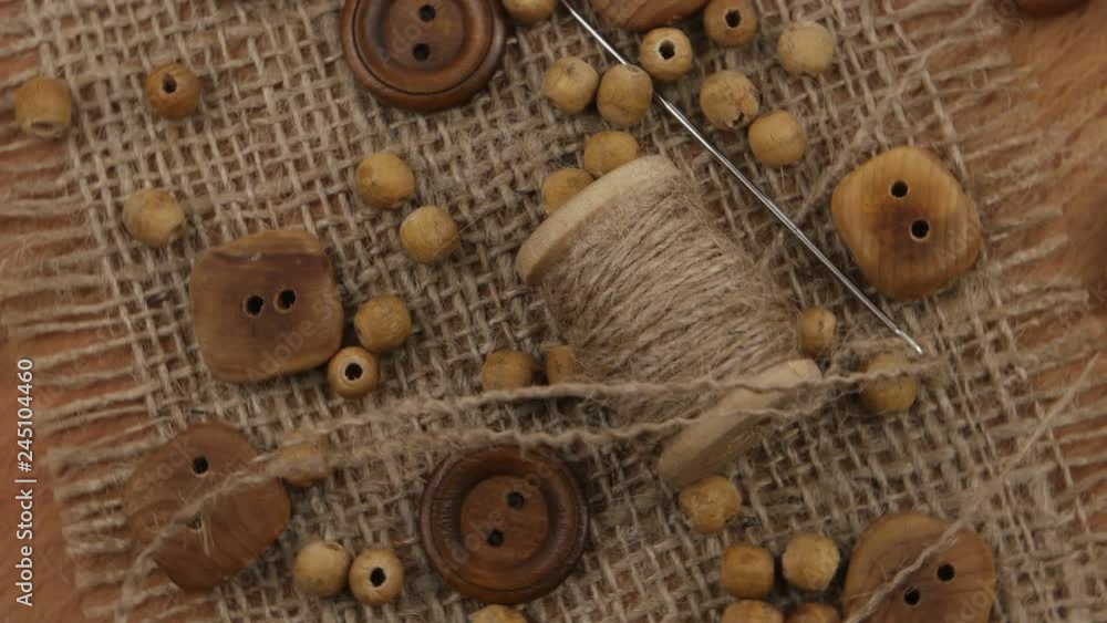 Accessories for sewing and needlework in style of eco fashion. Wooden buttons, burlap, jute cord and jute threads Accessories for sewing and needlework in style of eco fashion. Wooden buttons, burlap, jute cord and jute threads
