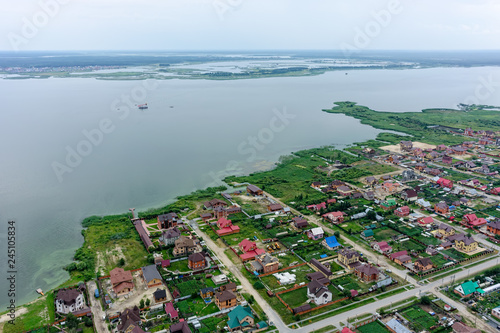 Aerial view onto private houses on bank of lake