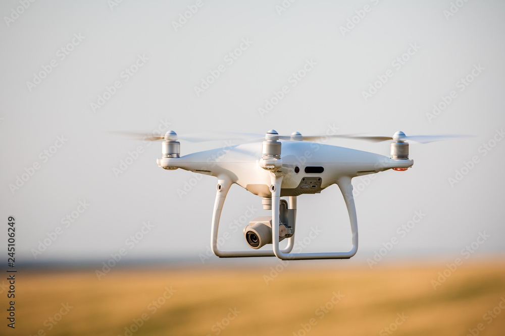 drone quad copter on green corn field drone quad copter on green corn field