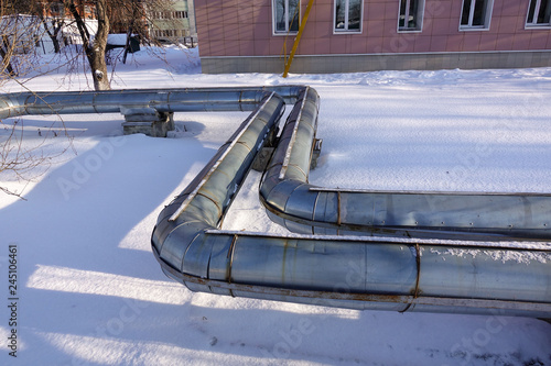 Overground heat pipes. Pipeline above ground, conducting heat for heating the city. Winter. Snow.