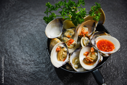 enamel venus shell cooking pan seafood plate with Shellfish Clams ocean gourmet dinner cooked with herbs and spices