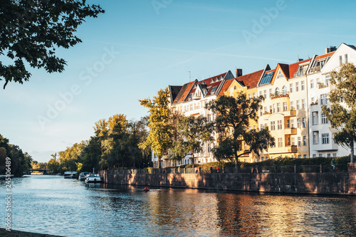 European building near the river with boats at sunny autumn day