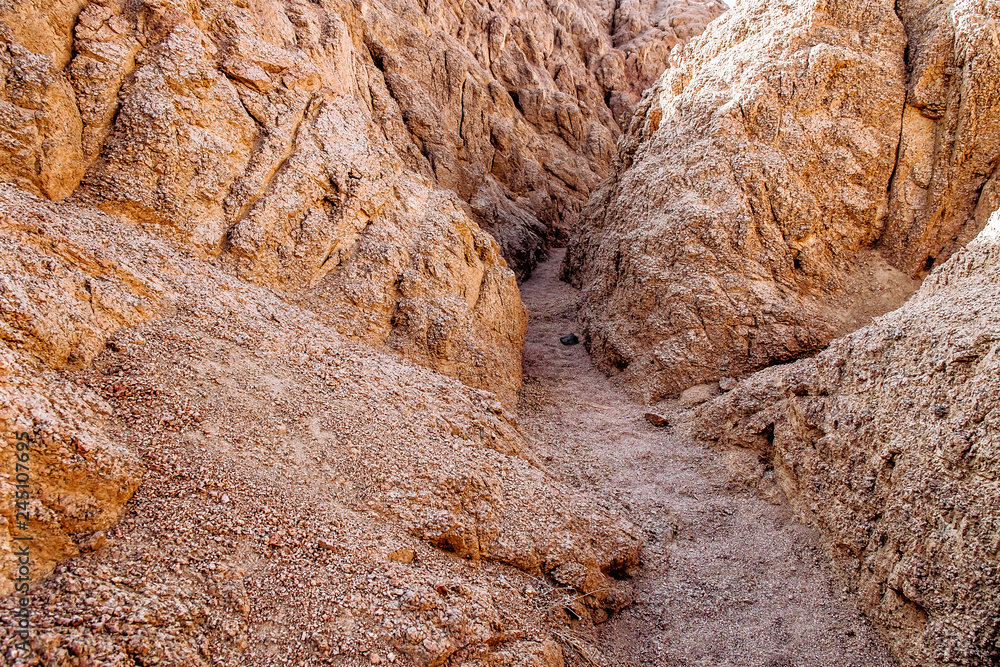 Entrance to Closed Canyon in the hiking trail in the desert region of Sinai Peninsula, Egypt. Rocks carved by winds, rugged mountains and hidden canyons in Sinai desert. Entrance to Closed Canyon in the hiking trail in the desert region of Sinai Peninsula, Egypt. Rocks carved by winds, rugged mountains and hidden canyons in Sinai desert.