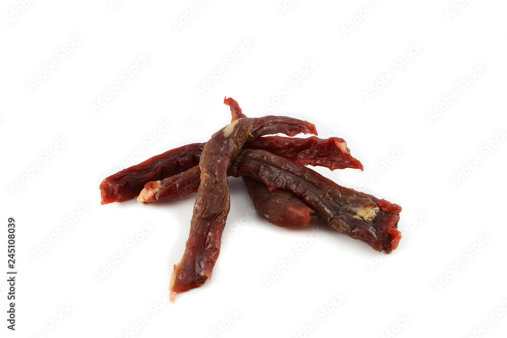 Long sliced of dried meat beef jerky dry isolated on white background Long sliced of dried meat beef jerky dry isolated on white background