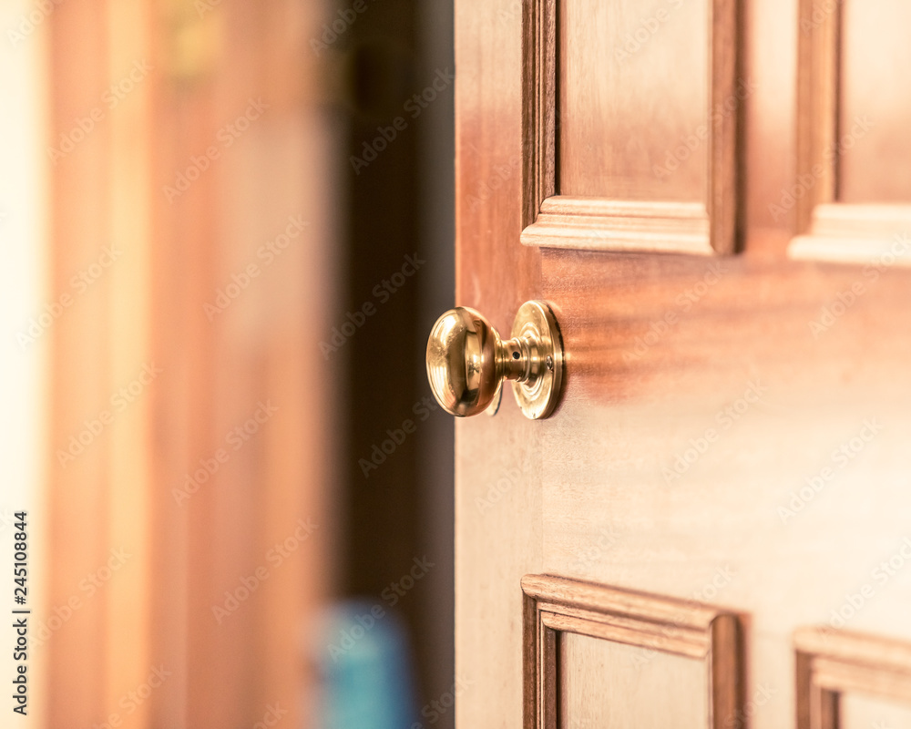 Buying new home, selling your home, inviting people over to your home, door knob, door handle, slightly opened wooden door in old fashioned vintage style house Buying new home, selling your home, inviting people over to your home, door knob, door handle, slightly opened wooden door in old fashioned vintage style house
