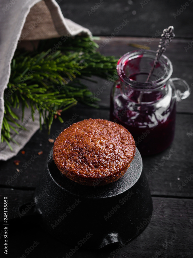 Little chocolate homemade muffin and cherry jam. Dark moody style. Selective focus
