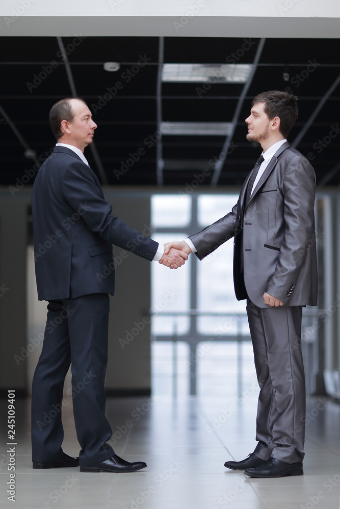 handshake of business partners in the corridor of the office handshake of business partners in the corridor of the office