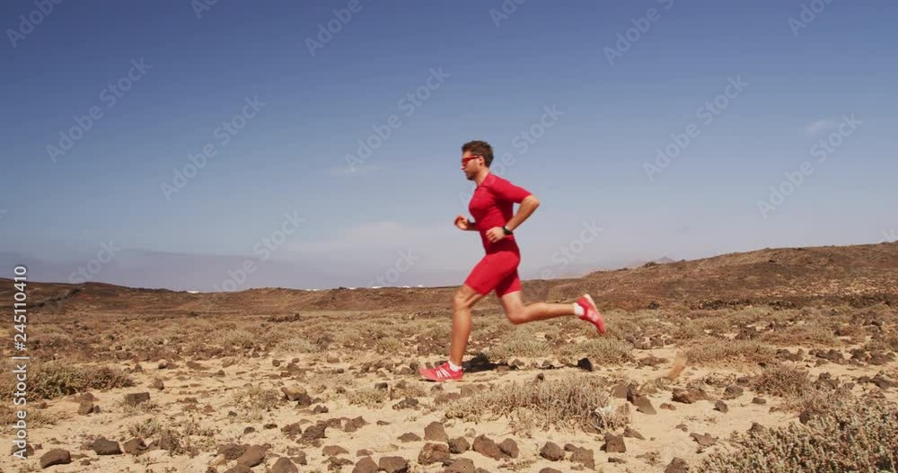 Male athlete training at running trail in desert landscape in Slow motion. Man runner. Male athlete training at running trail in desert landscape in Slow motion. Man runner.