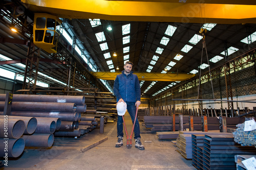 worker with pipes in a factory