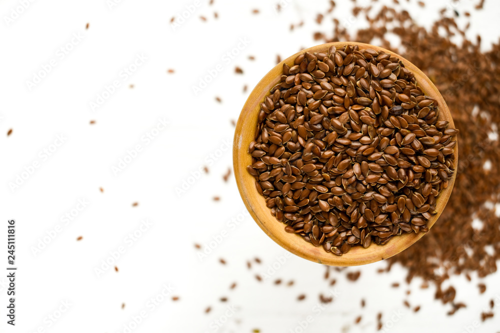 flax seed on white background,food,isolated,brown,seeds,dry,ingredient,organic,healthy,oil,wood,cup. flax seed on white background,food,isolated,brown,seeds,dry,ingredient,organic,healthy,oil,wood,cup.