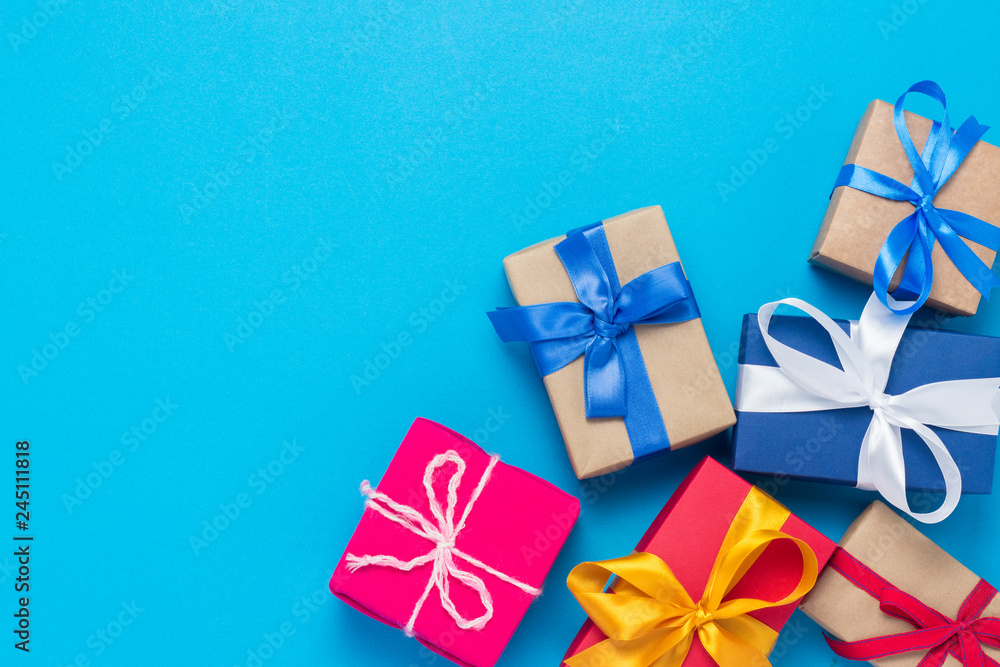 A lot of gift boxes on a blue background. Holiday concept, New Year, Christmas, Birthday, Valentine's Day. Copy space. Flat lay, top view A lot of gift boxes on a blue background. Holiday concept, New Year, Christmas, Birthday, Valentine's Day. Copy space. Flat lay, top view