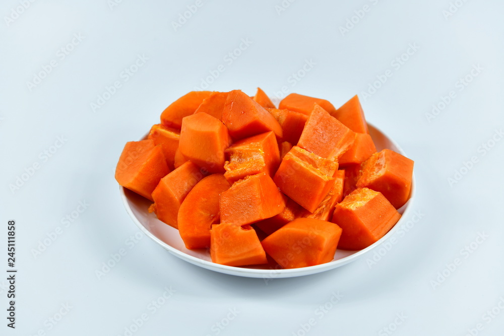 Slices of papaya on white background.