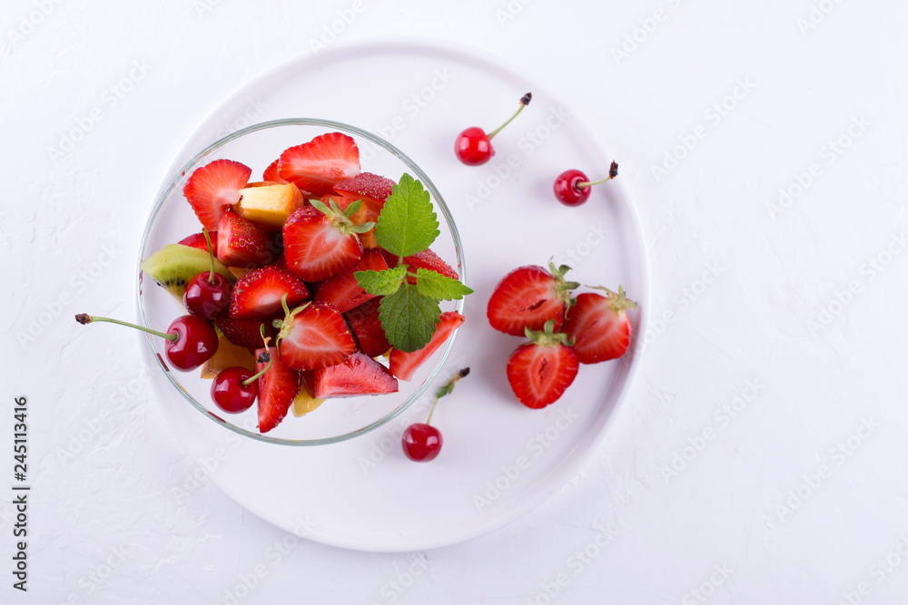 Fruit salad of strawberries, kiwis and apricots. Fresh and tasty snack Top view Fruit salad of strawberries, kiwis and apricots. Fresh and tasty snack Top view