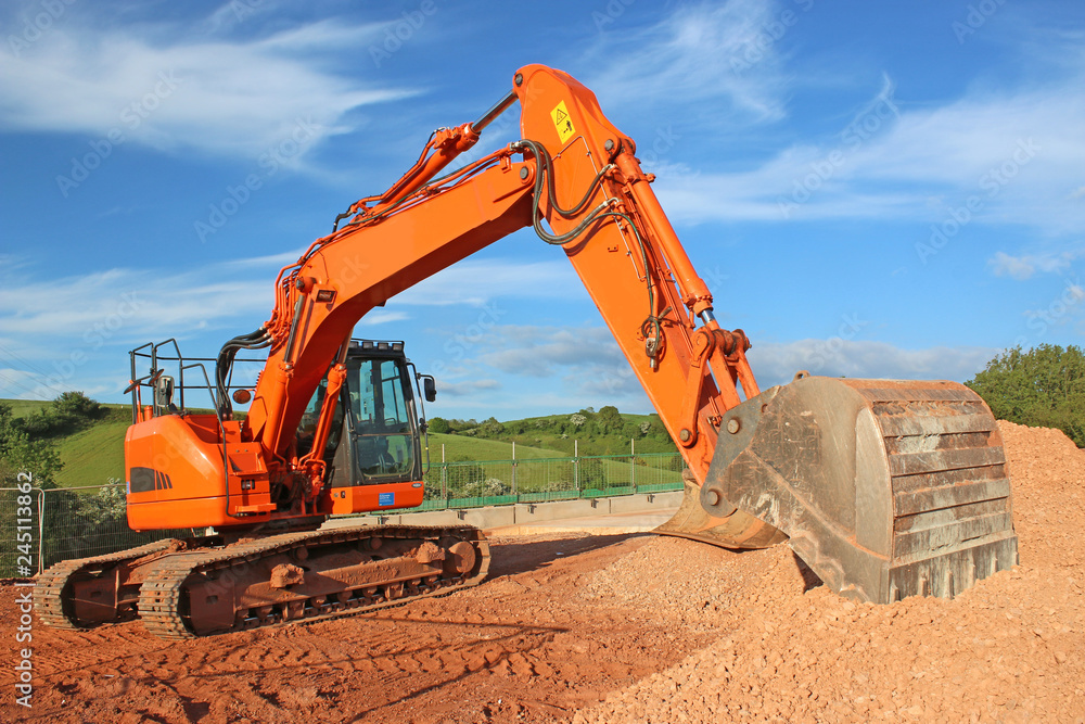 Digger on a road construction site Digger on a road construction site