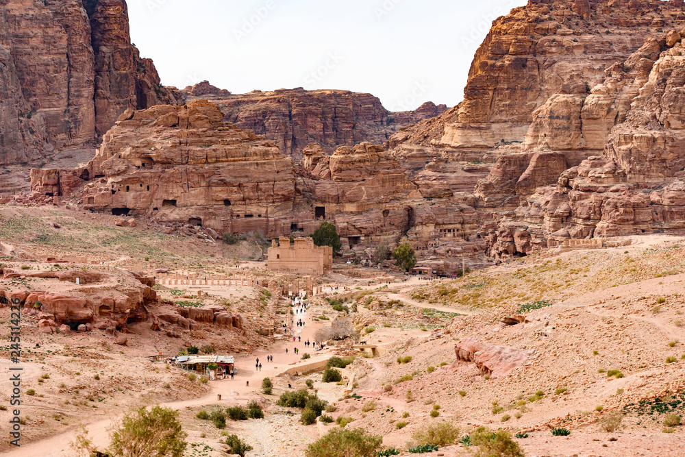 Amazing view of a beautiful canyon in Petra with the historical and archaeological city in distance. Petra is a Unesco World heritage site,  in southern Jordan.
