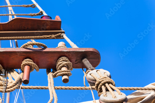 Vintage Sailboat Rigging / Jacobs ladder made of ropes at old sailing ship on nostalgic cruise, blue sky background (copy space)