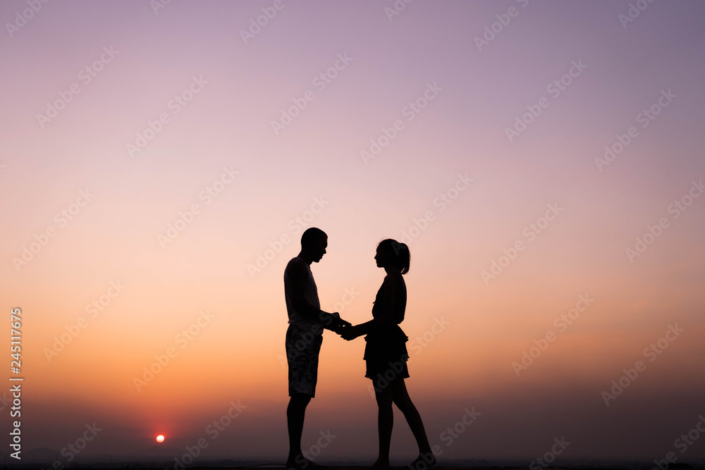 silhouette of couple holding hand at sunset silhouette of couple holding hand at sunset