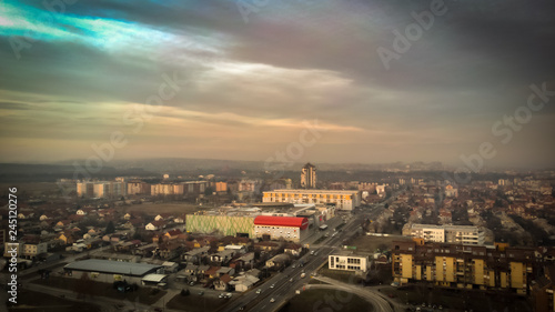 Aerial view of sunset in Kragujevac town in Serbia, cloudy winter day © Milan